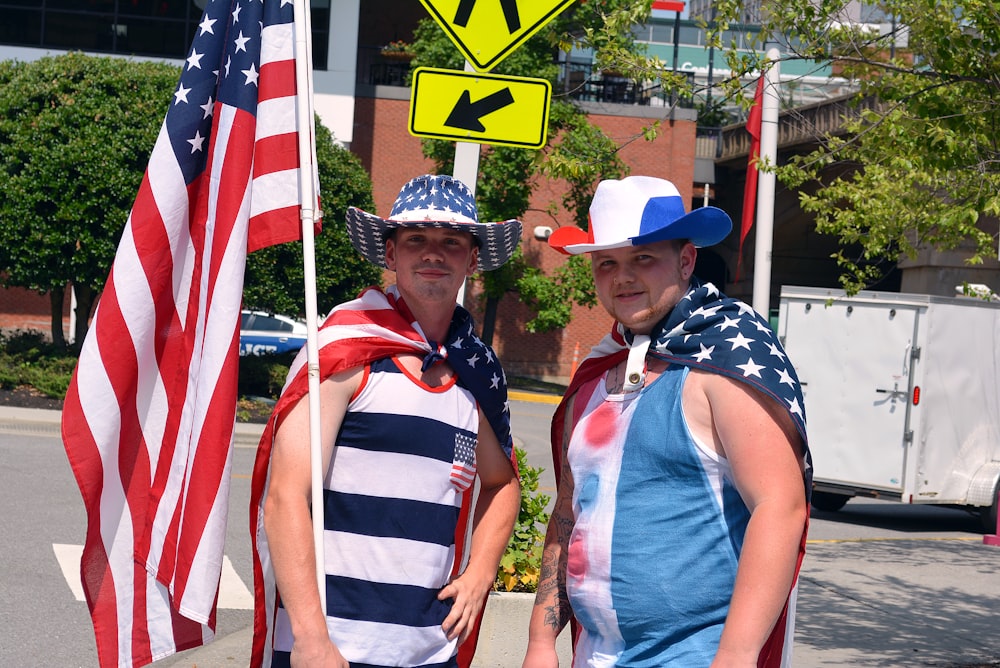 two men in tank tops holding USA flag