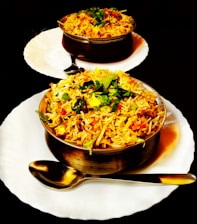 two plates of food on a black table