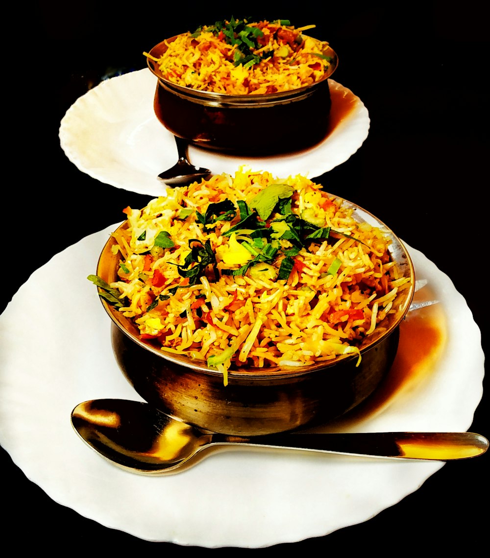 two plates of food on a black table