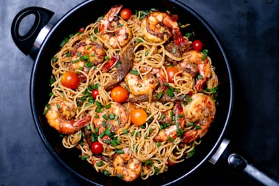 cooked noodles with shrimps dish teams background