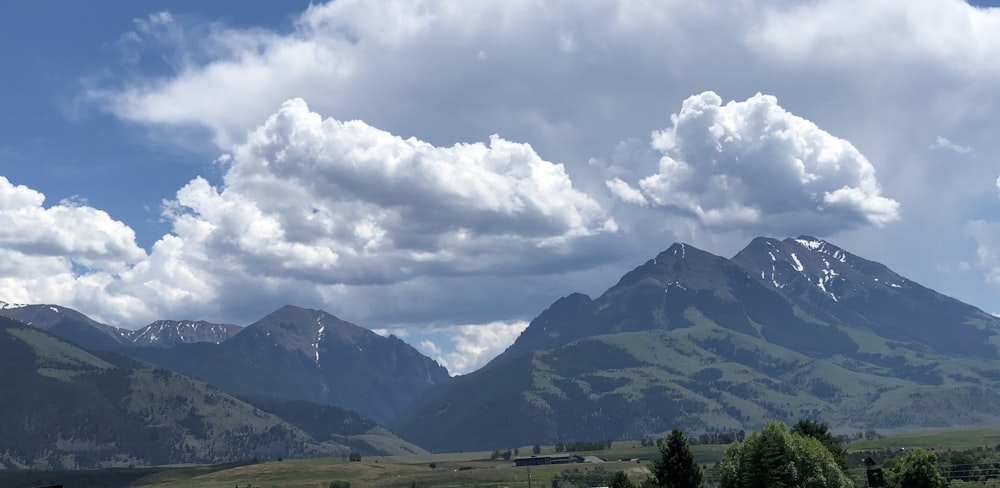 green mountain under white cloudy skies