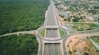 an aerial view of a highway intersection in the middle of a city