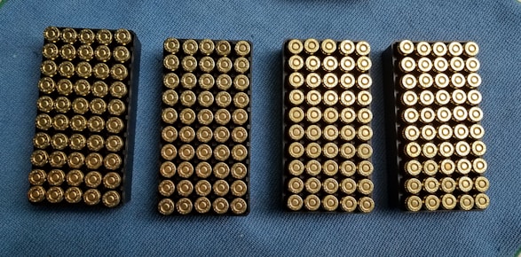 Rows of neatly arranged ammunition boxes with various calibers visible.