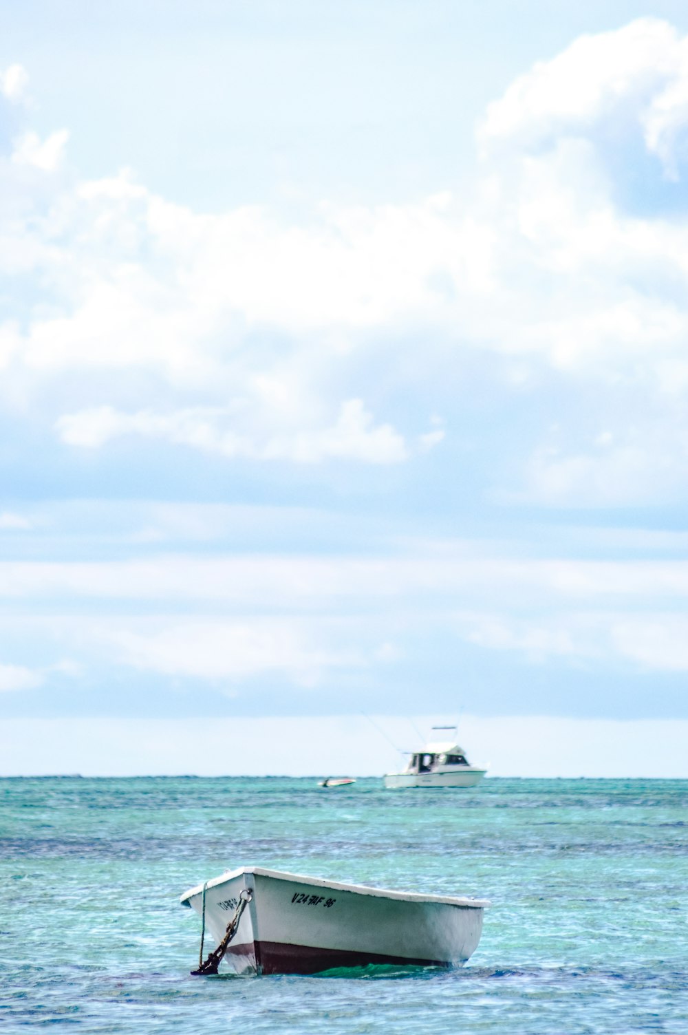 white row boat at the body of water