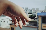 Two colleagues shaking hands with a cityscape in the background.