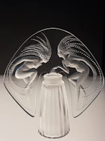 A delicate sculpture of intertwined figures capturing movement and grace.