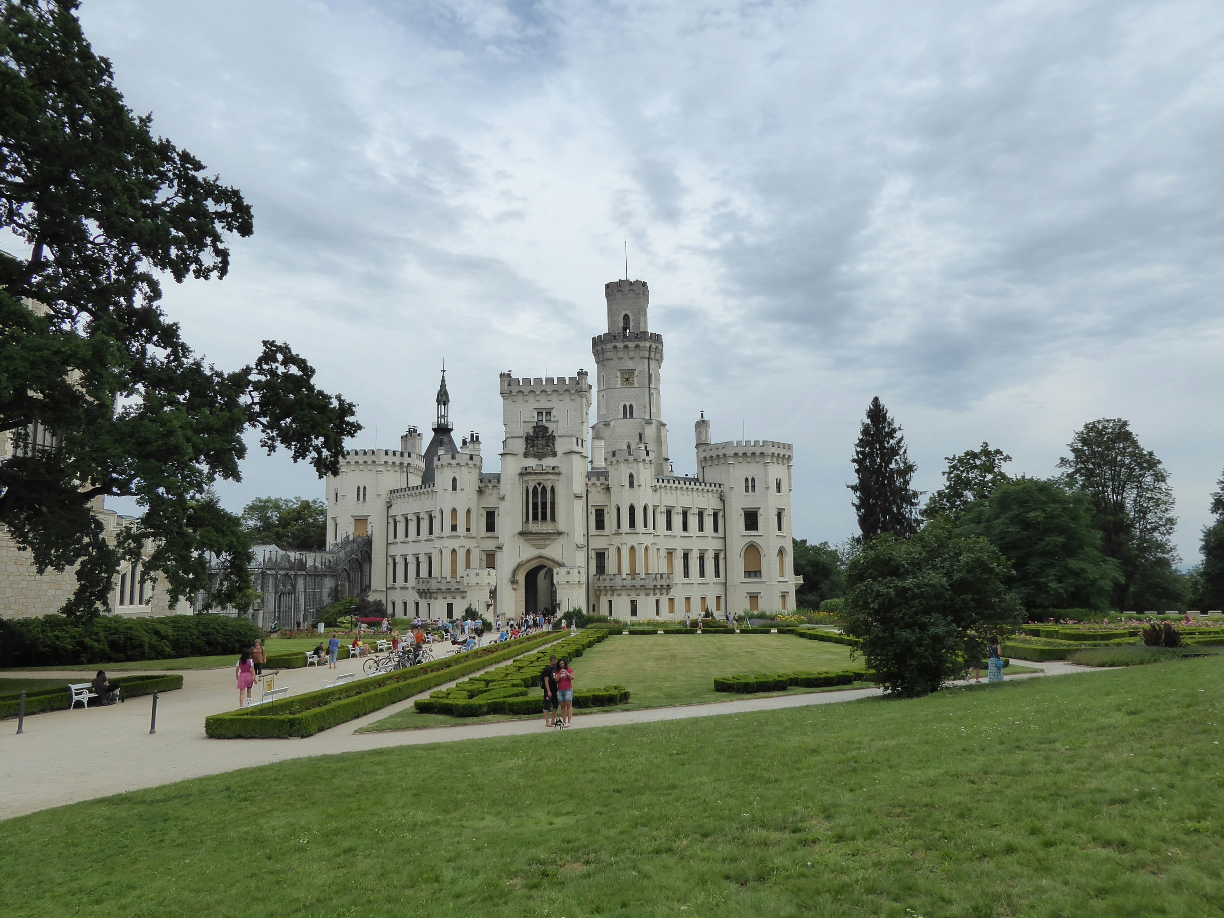 A Large White Castle Sitting On Top Of A Lush Green Field