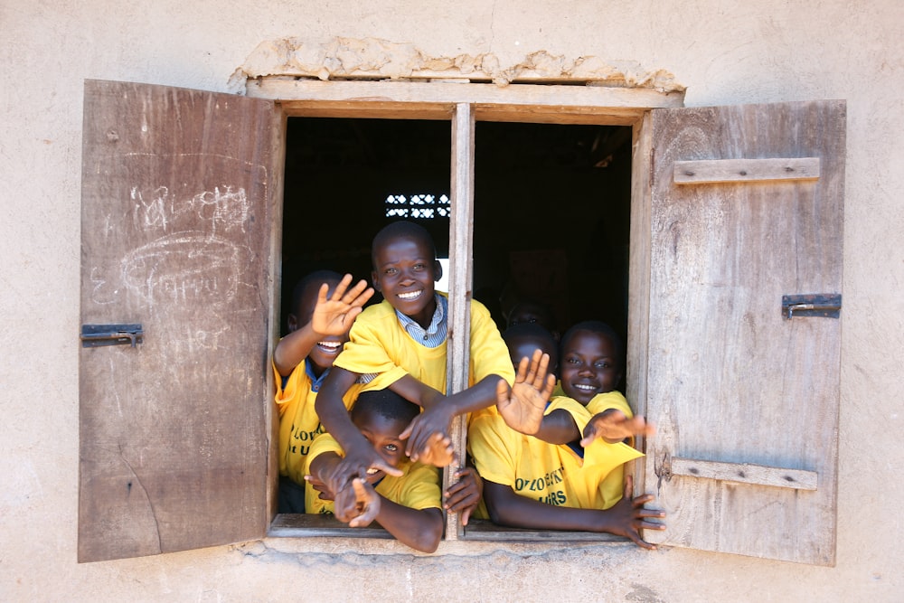 children at the window of a building