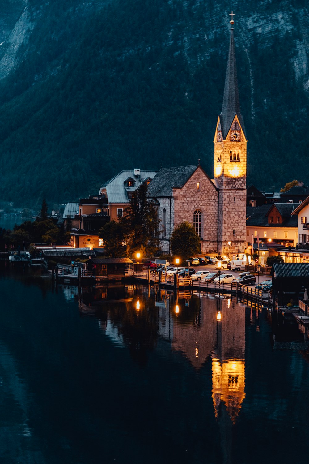 a church lit up at night on a lake