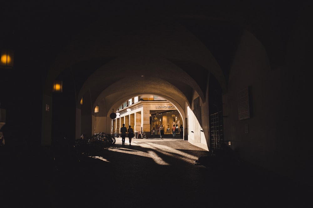 two people walking on tunnel