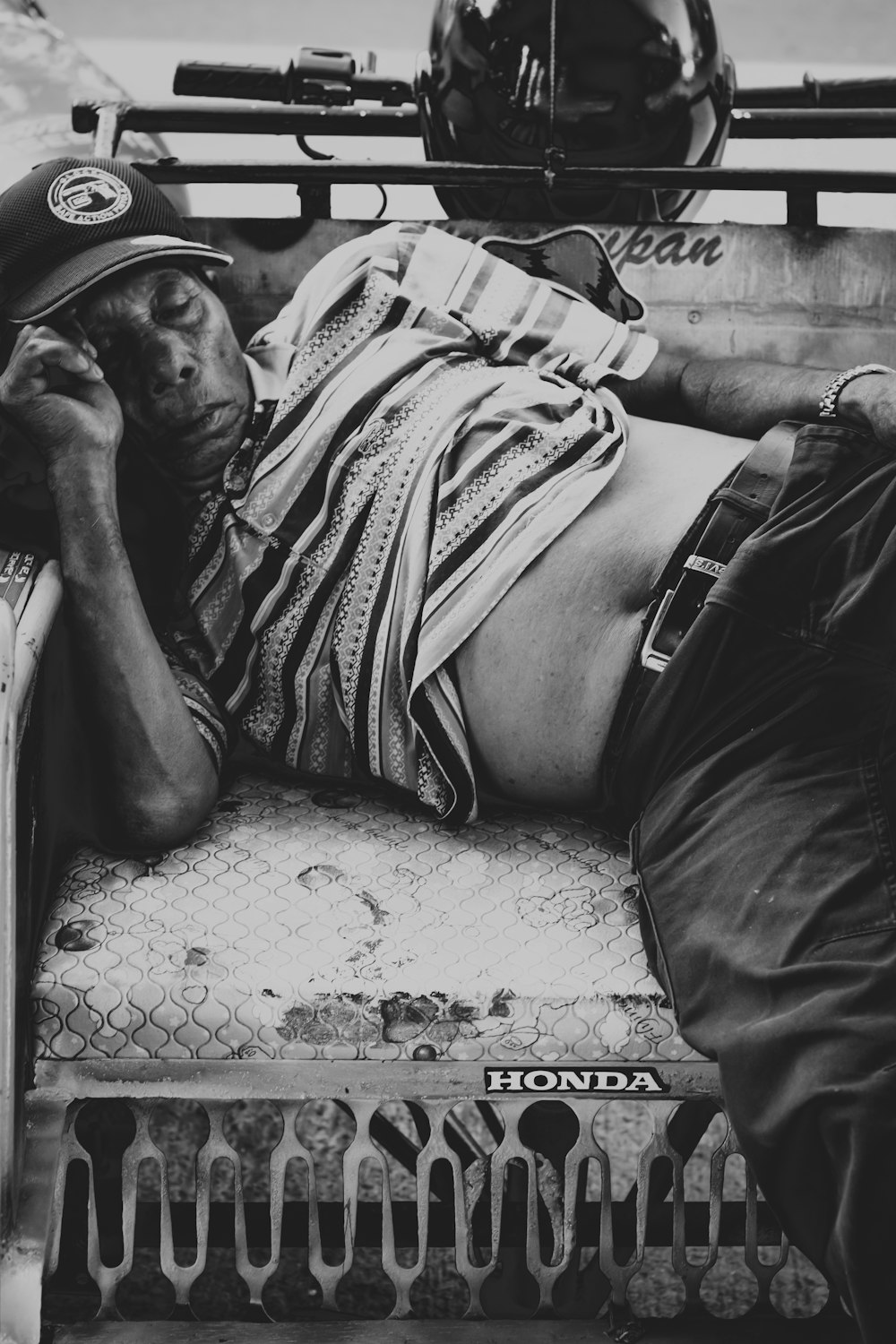 man sleeping grayscale photo