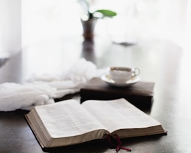A serene, minimalist setting with a leadership book open beside a cup of coffee.