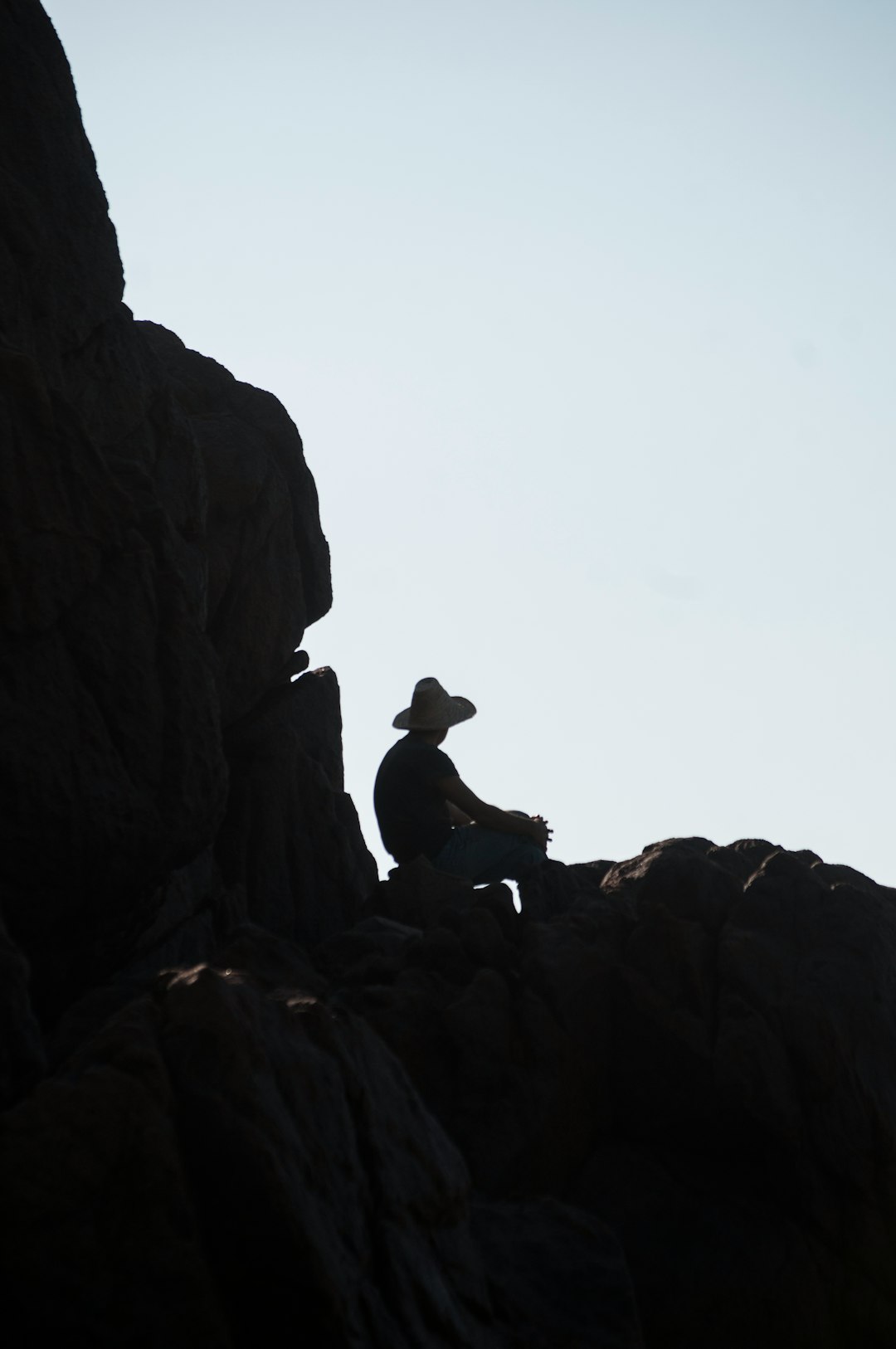 man sitting on rock