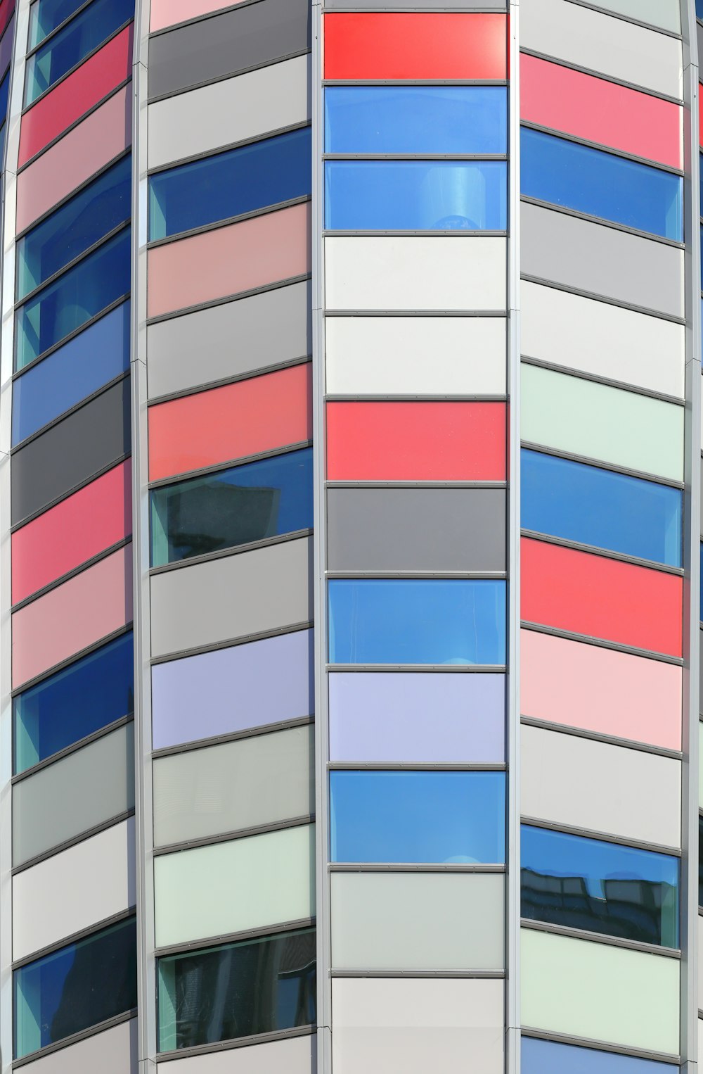 a multicolored building with a clock on the side of it