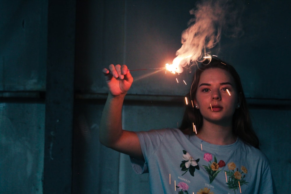 woman holding sparkling stick