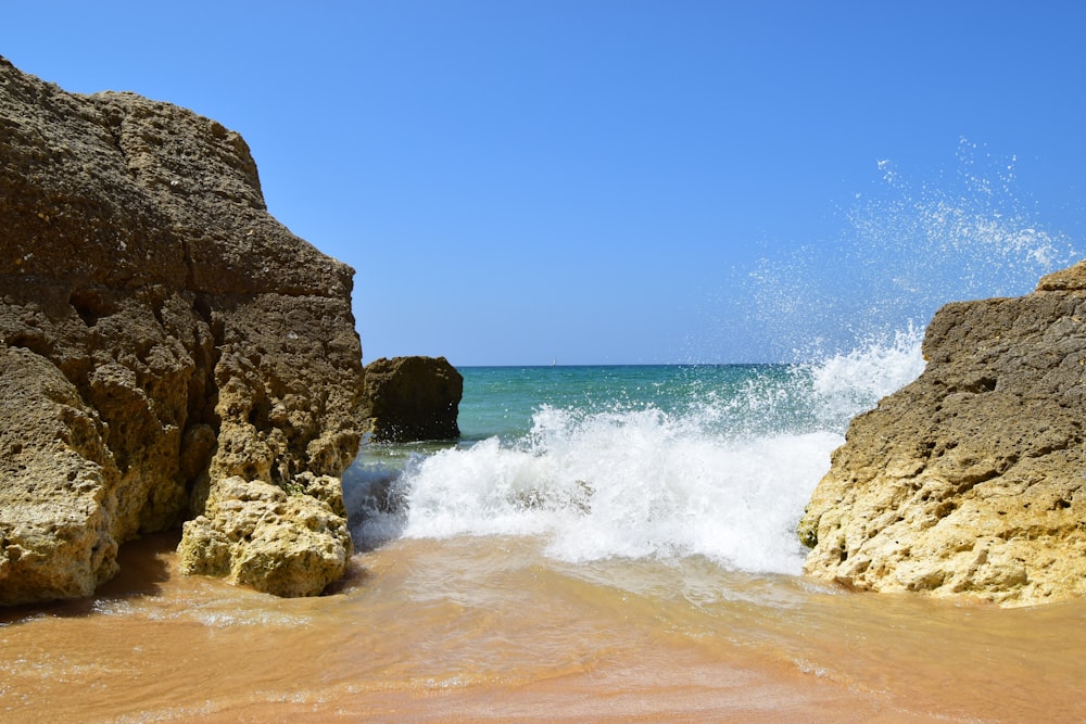 water splashing to rocky shore