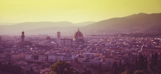 A warm sunset view of Milan’s Duomo cathedral with people admiring the rooftop.