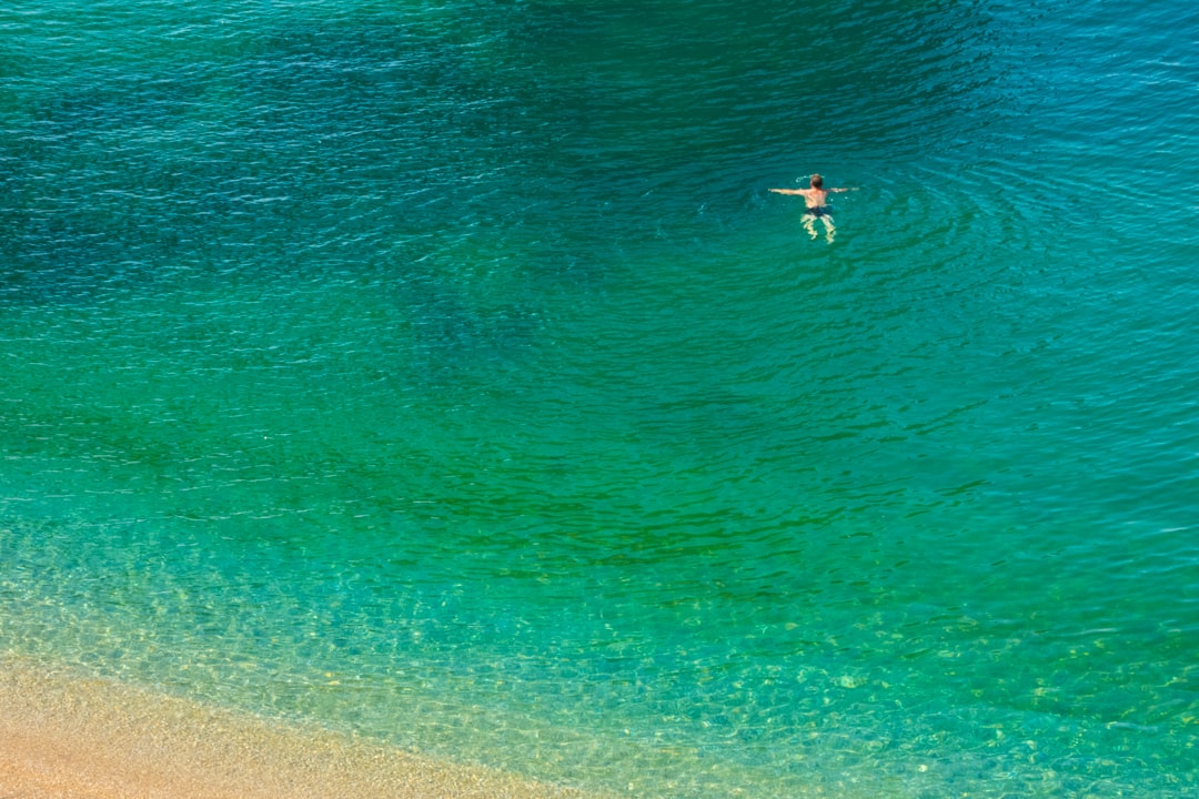 person in body of water during daytime