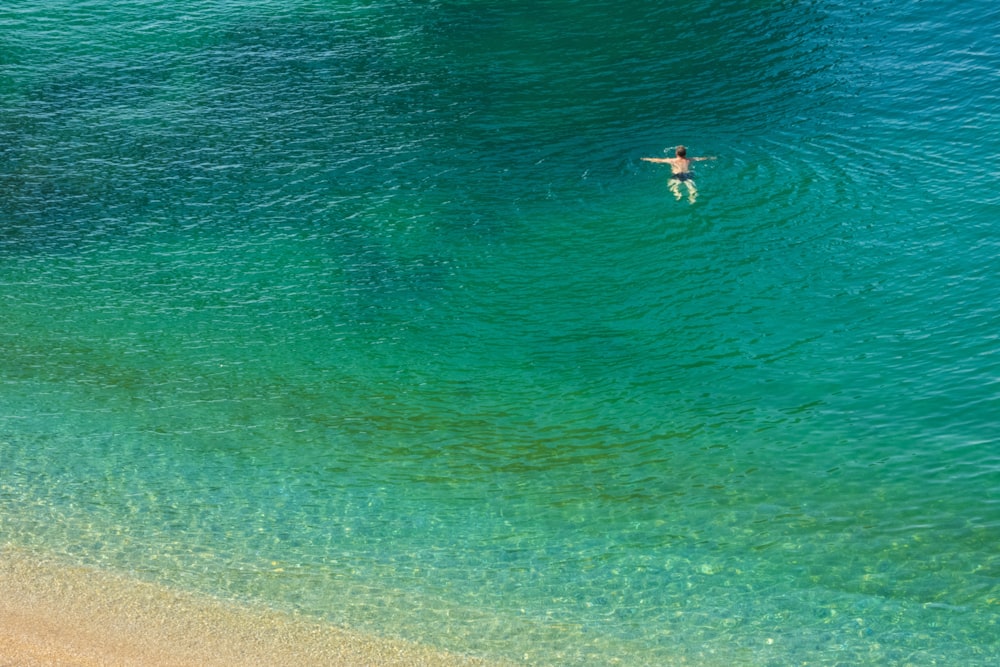 person in body of water during daytime