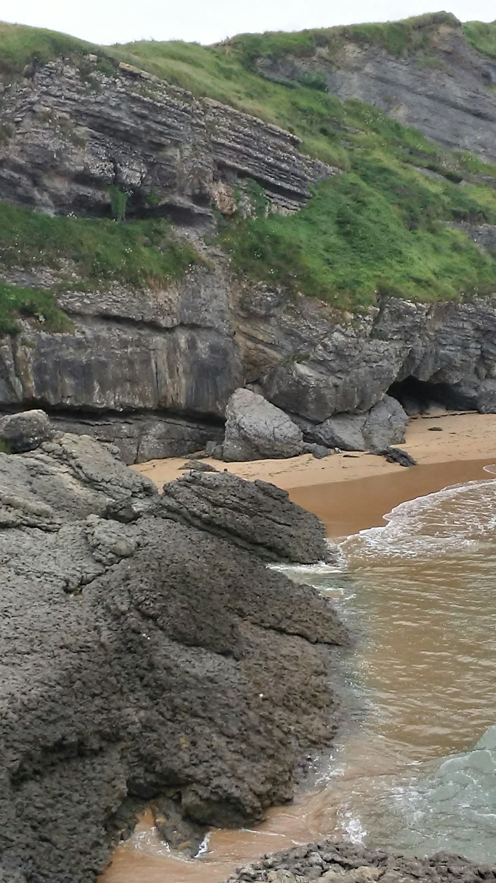 grey cliff near body of water