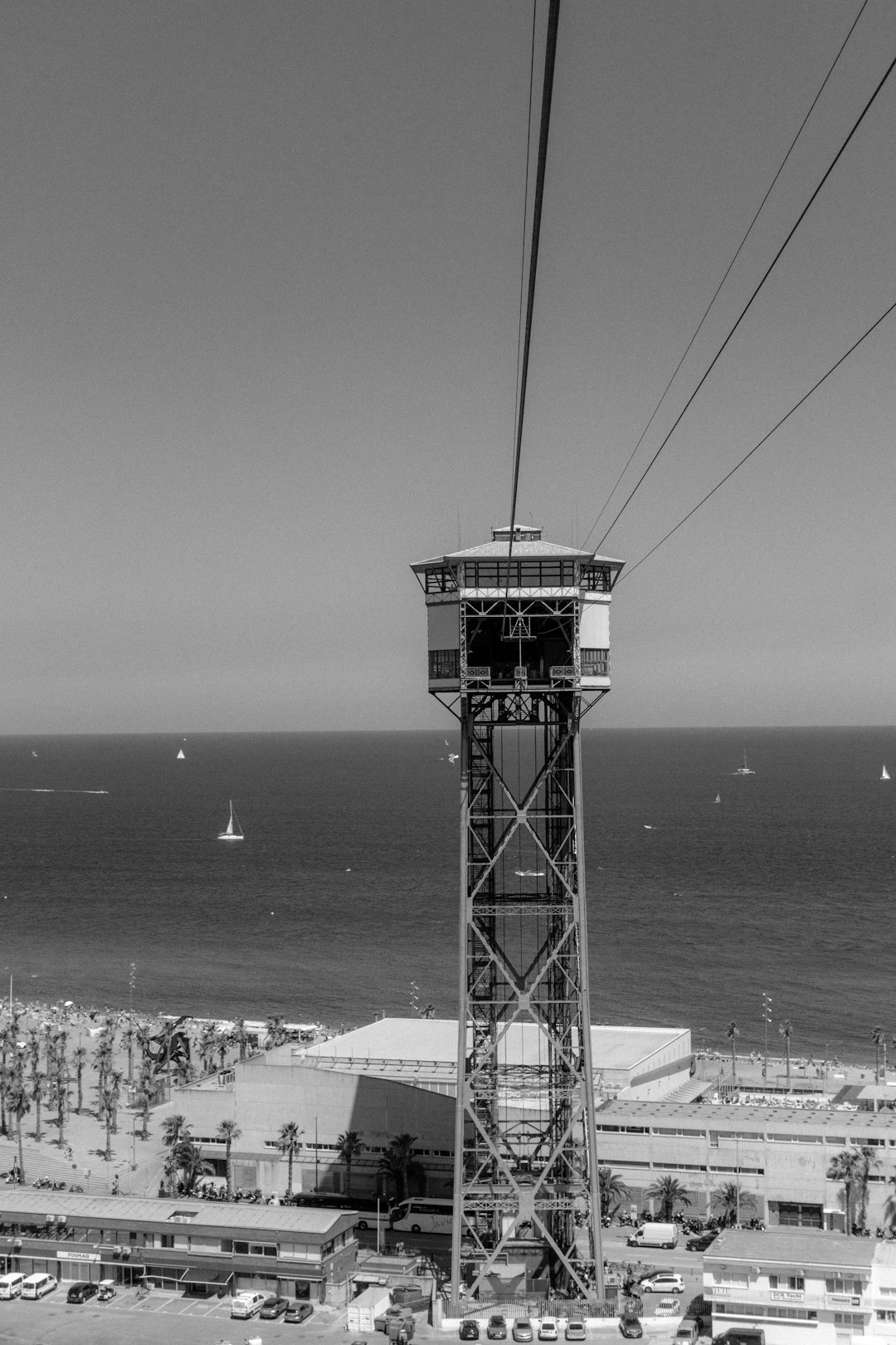 grayscale photography of building near beach