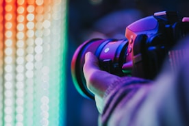 person holding DSLR camera