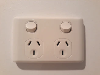 Close-up of modern electrical switches and outlets mounted on a wall.