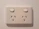 Electrician carefully replacing an old electrical outlet in a residential apartment.