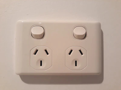 Various types of electrical switches and outlets displayed on a wooden surface