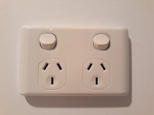 Neatly installed electrical outlets and switches in a bright, newly renovated living room.