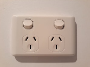 Electricians testing electrical sockets and switches in a modern kitchen