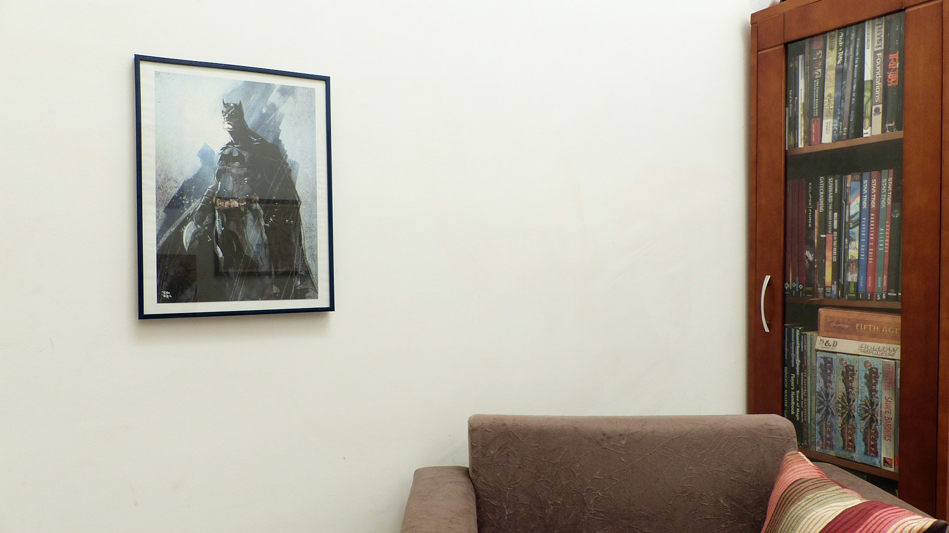 A cozy home setup with a big screen showing a popular superhero movie, surrounded by geeky collectibles.