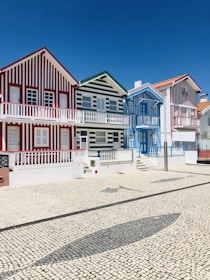 white and red house under blue sky at daytime