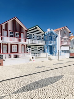 white and red house under blue sky at daytime