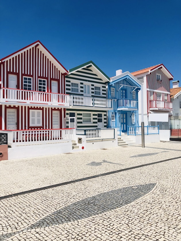 white and red house under blue sky at daytime
