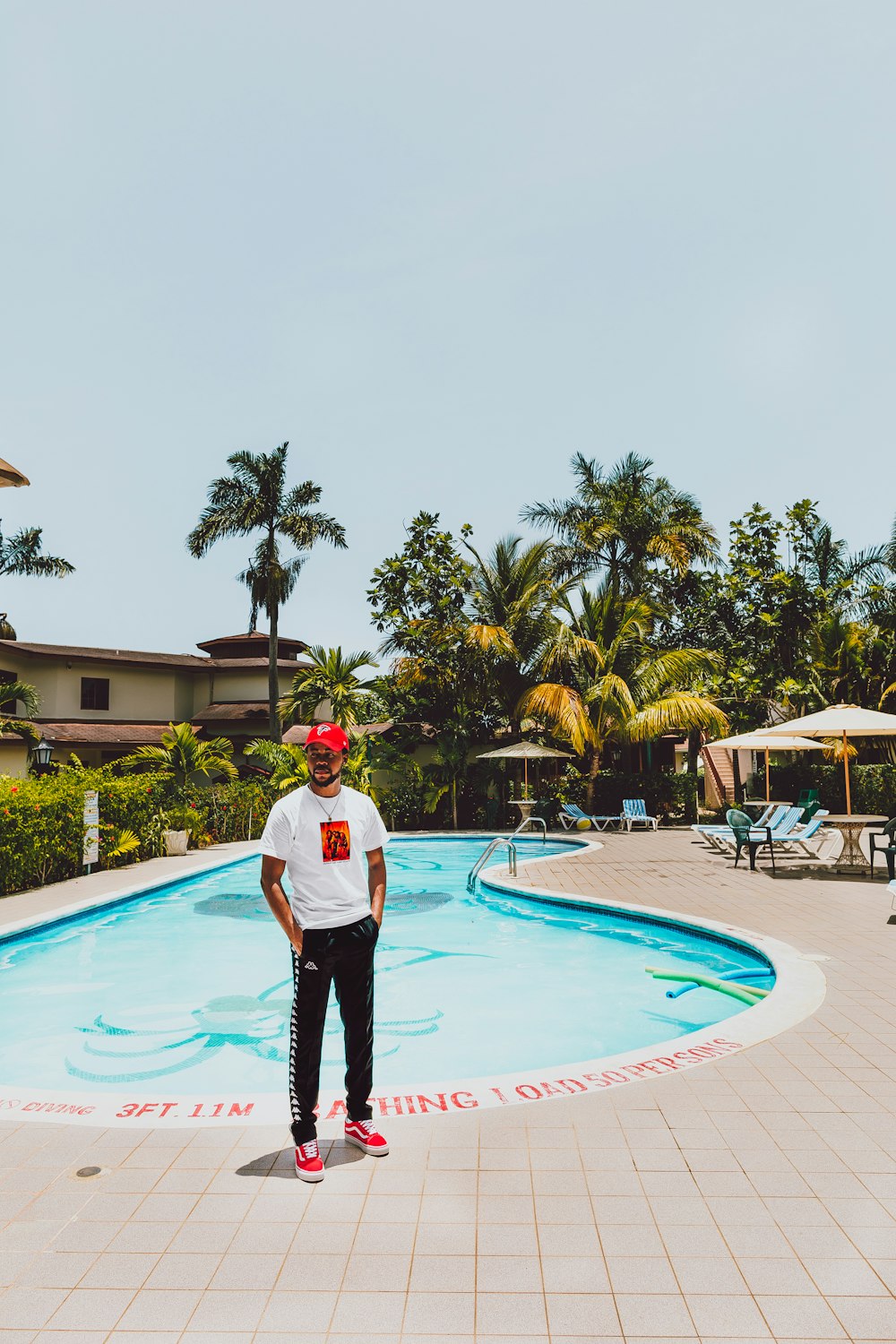 man standing near pool