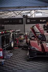 Battery pack and fan unit resting on a garage floor, ready for the next race day.