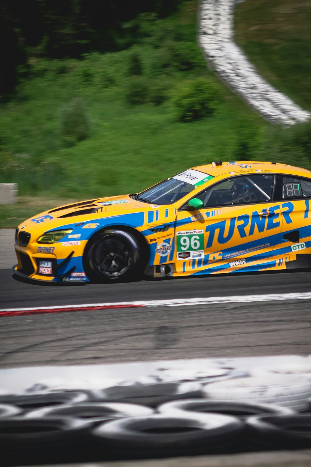 yellow and blue car on road