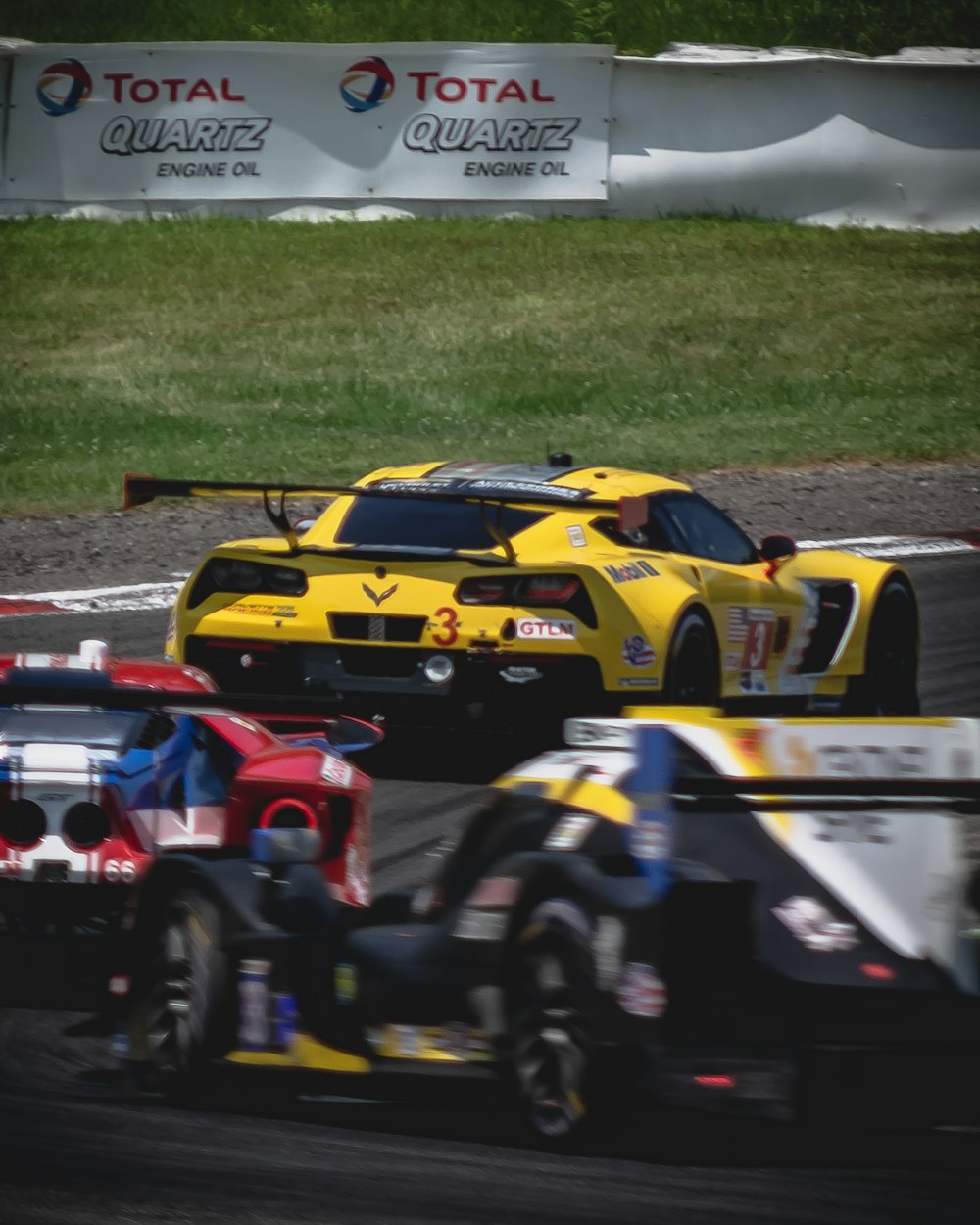 shallow focus photo of yellow race car