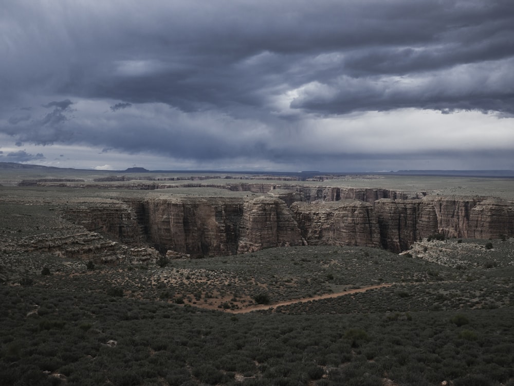 storm clouds hover over a vast desert landscape