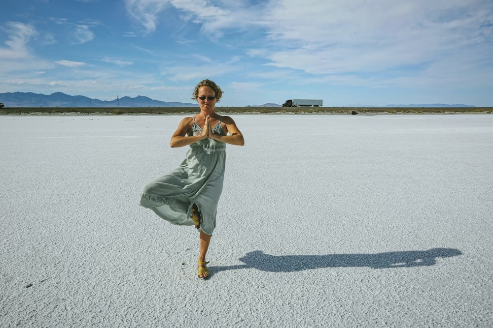 a woman standing in the middle of a desert