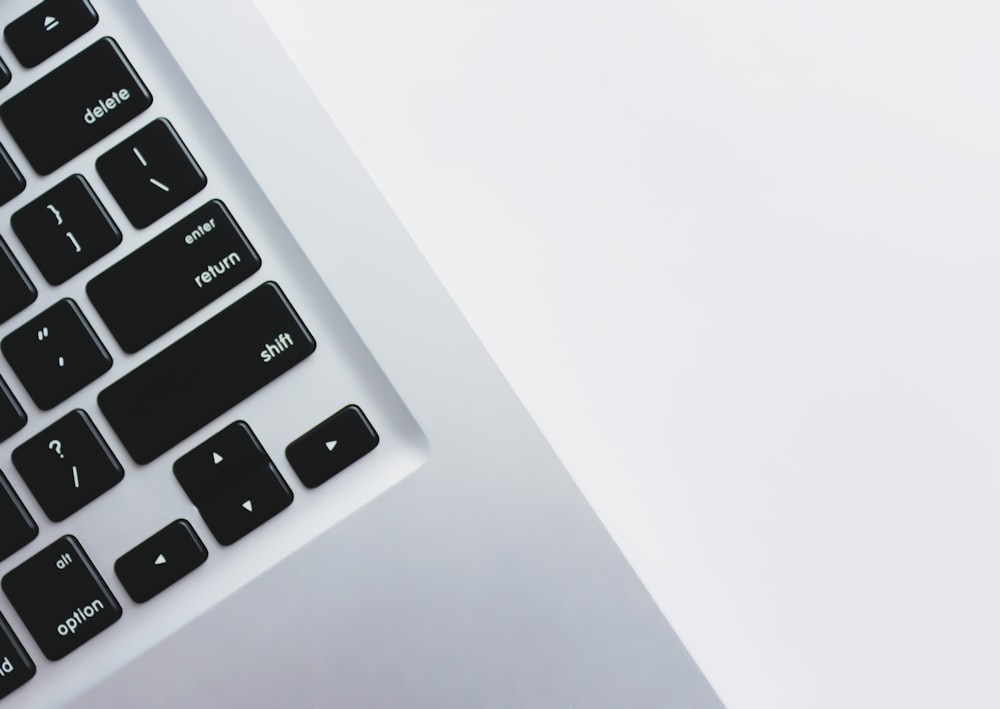 a close up of a keyboard on a white surface