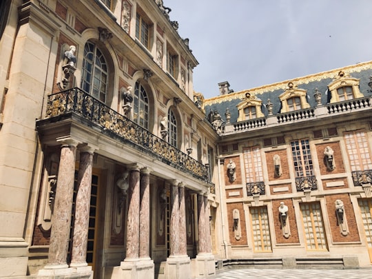 brown concrete building in Palace of Versailles France