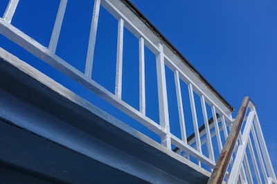 a white railing and a blue sky in the background