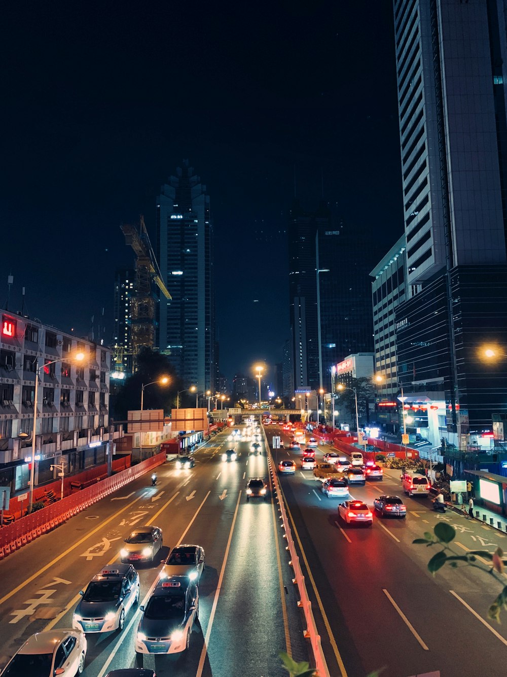 a city street filled with lots of traffic at night