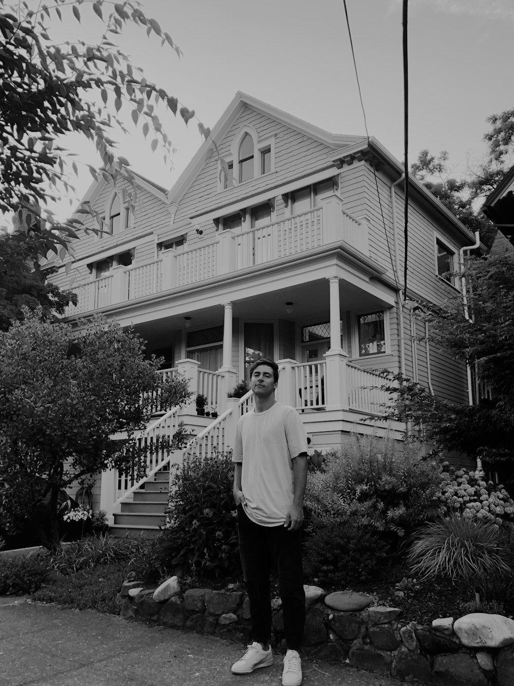 man standing in front of house