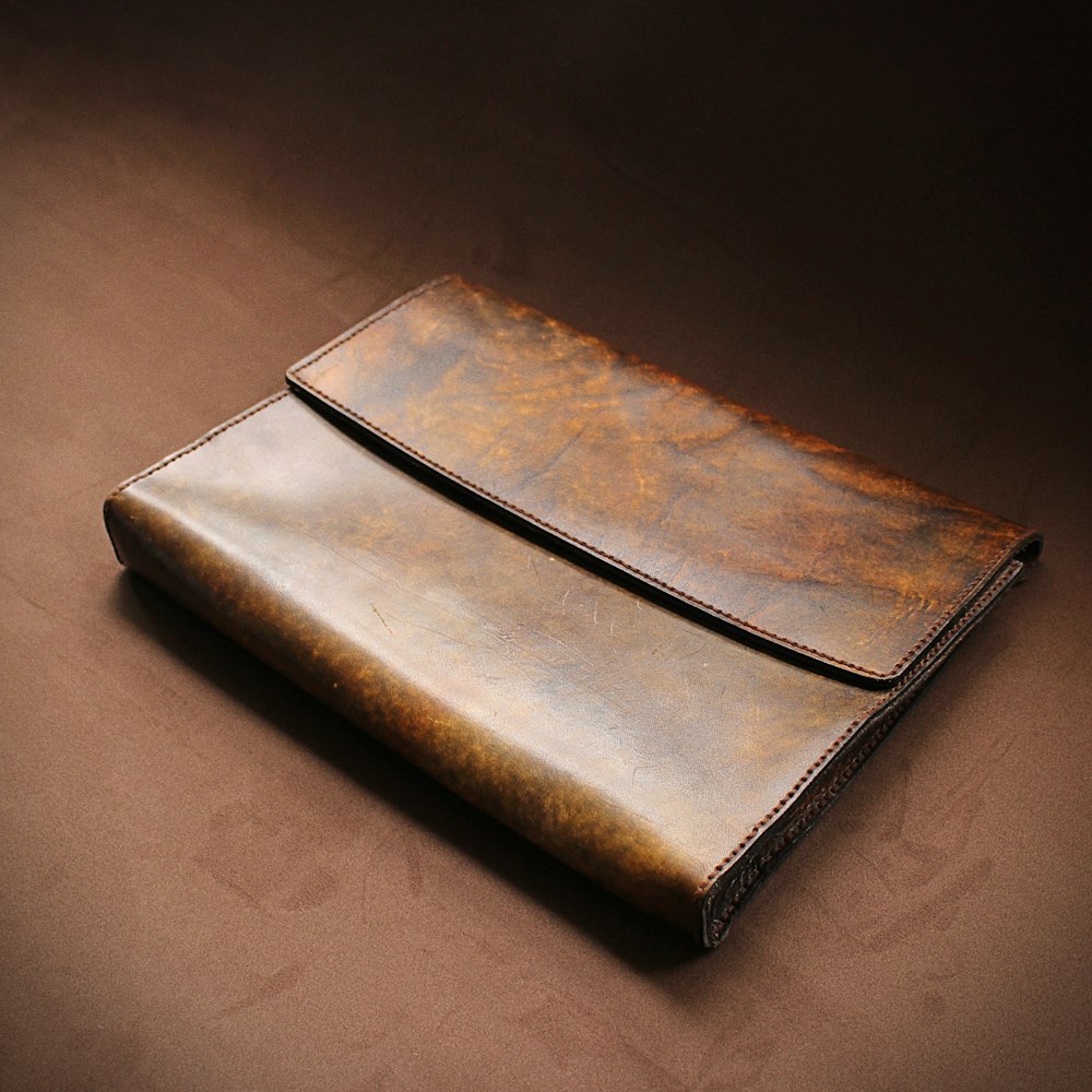 a brown leather case sitting on top of a table