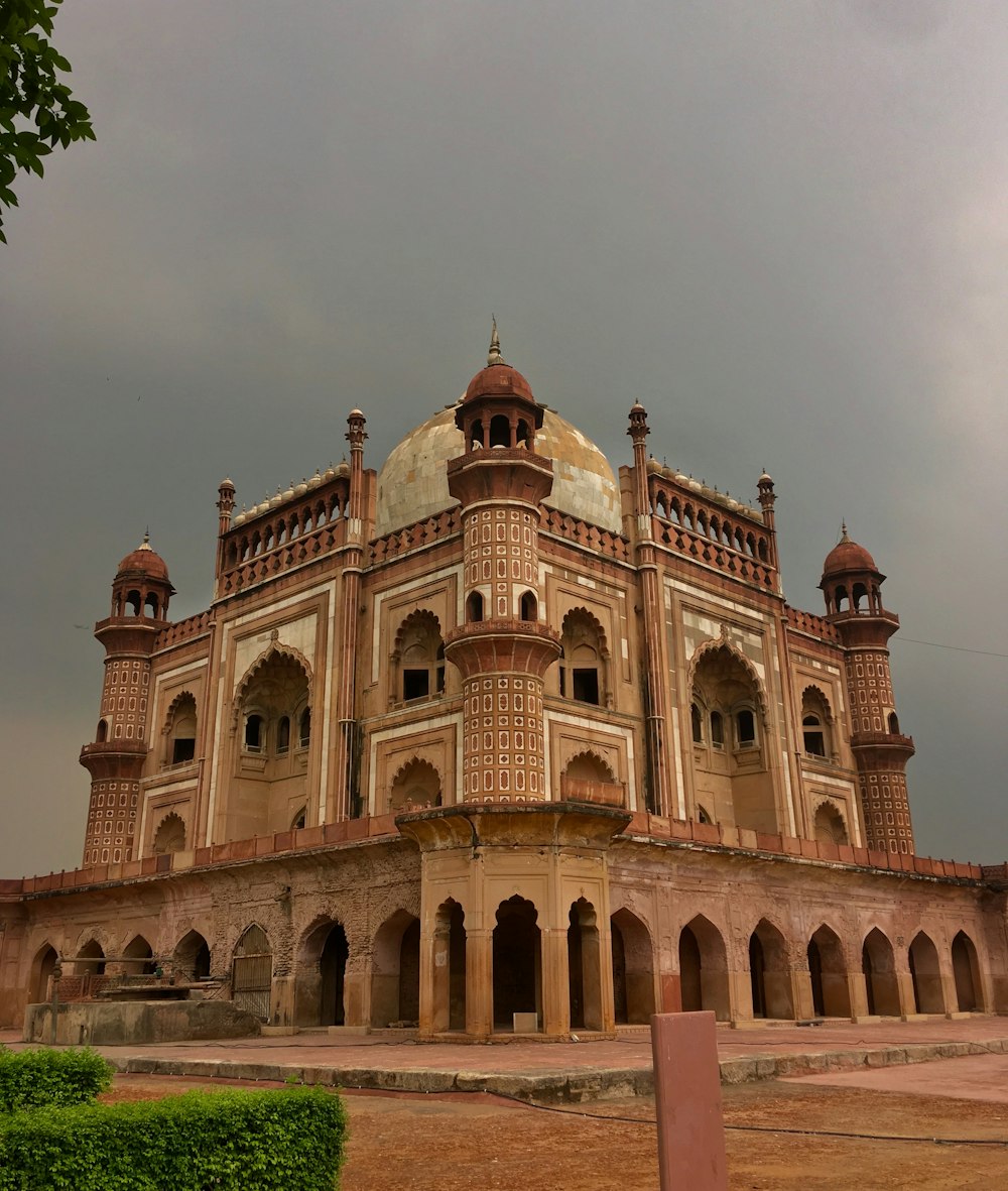 brown mosque under gray sky