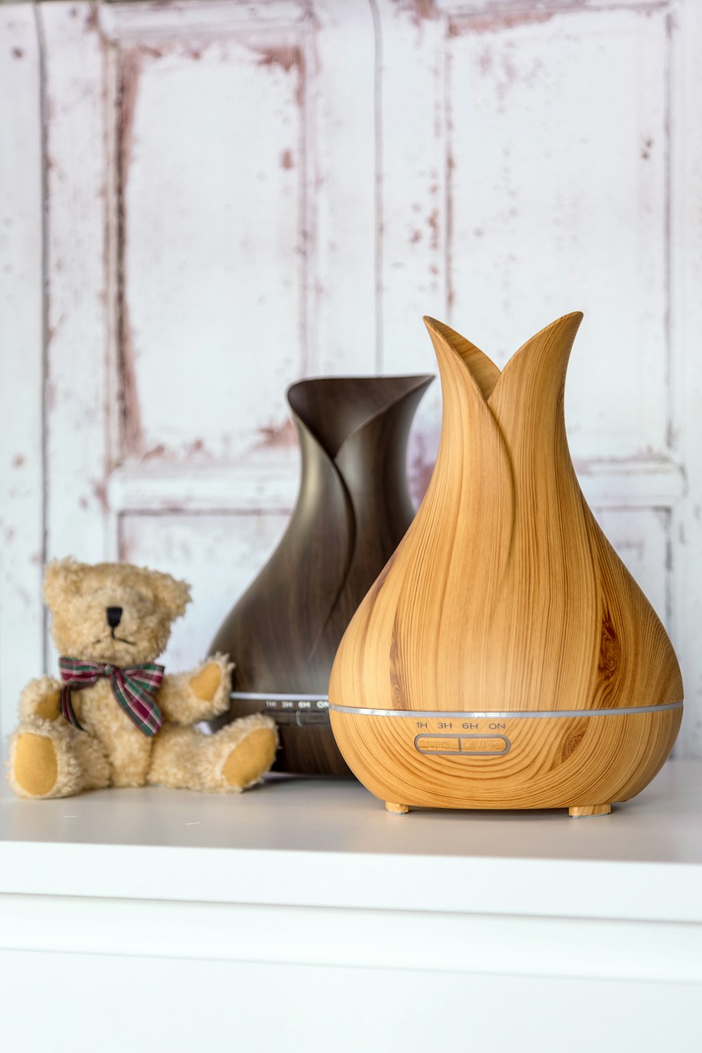 two brown diffusers beside plush toy
