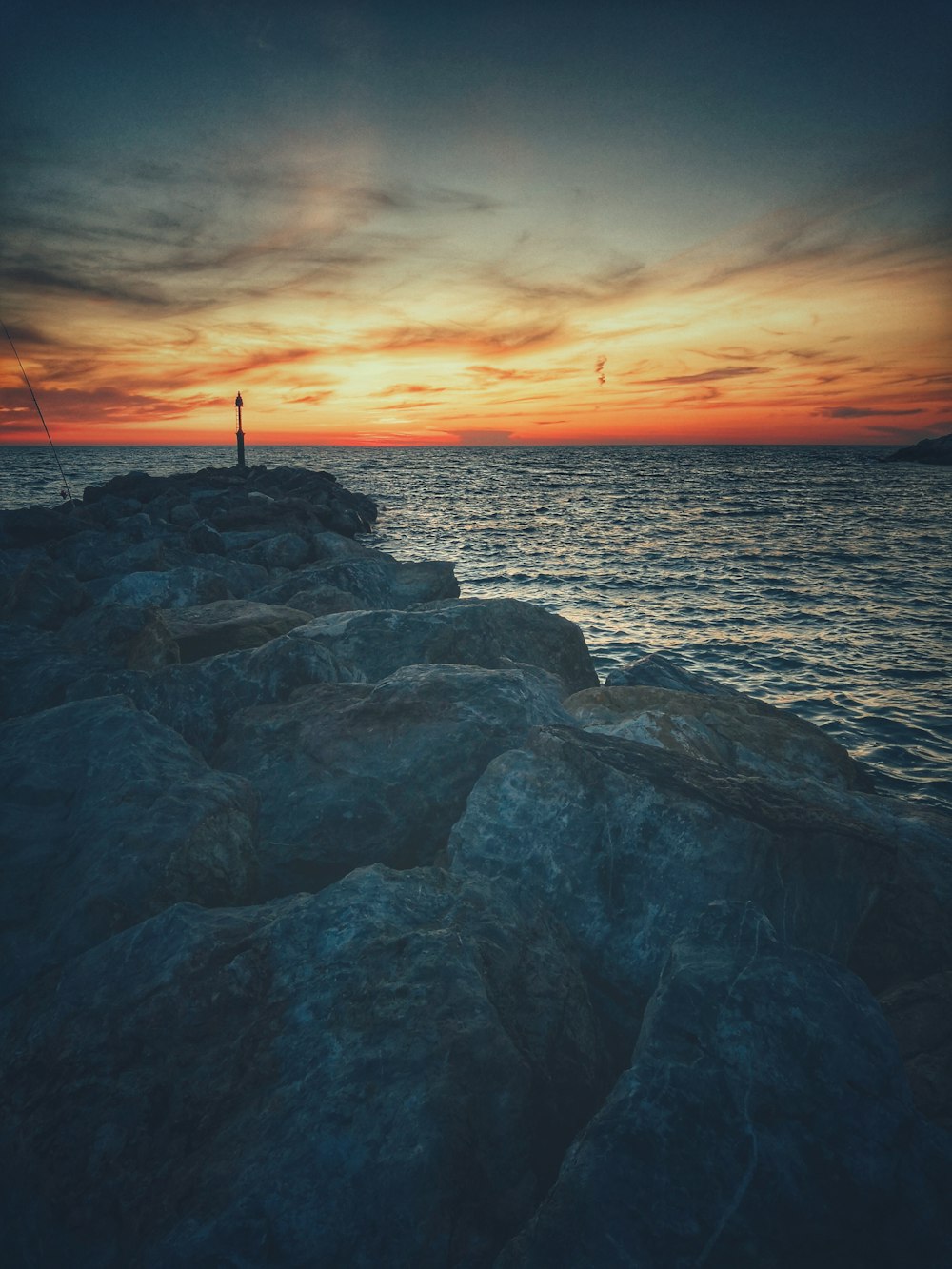 rock formation beside body of water